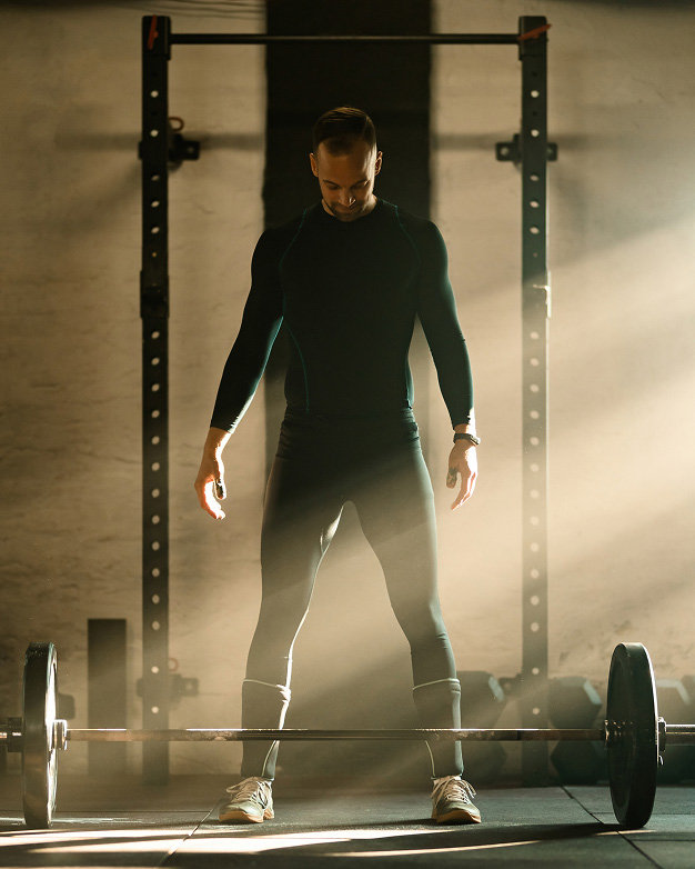 Man Deadlifting in Gym